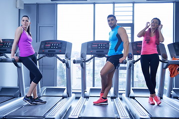 Image showing Group of people running on treadmills