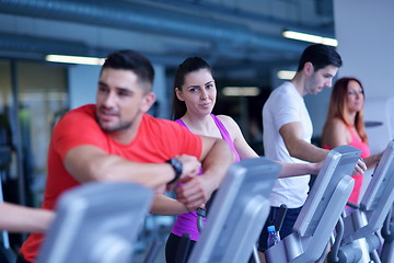 Image showing Group of people running on treadmills