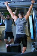 Image showing handsome man exercising at the gym