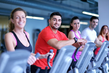 Image showing Group of people running on treadmills