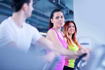 Image showing Group of people running on treadmills