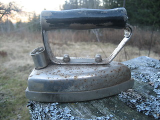 Image showing Old flat iron displayed outdoors