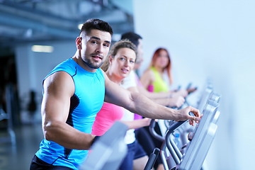 Image showing Group of people running on treadmills