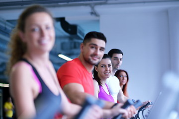 Image showing Group of people running on treadmills