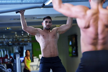 Image showing handsome man exercising at the gym