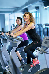 Image showing Group of people running on treadmills