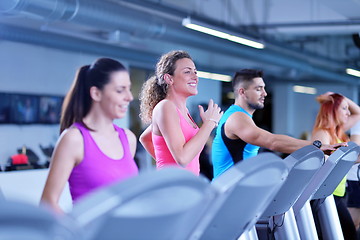 Image showing Group of people running on treadmills