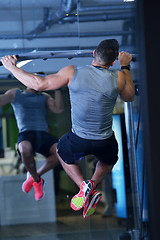 Image showing handsome man exercising at the gym