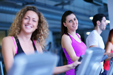 Image showing Group of people running on treadmills