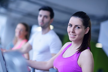 Image showing Group of people running on treadmills