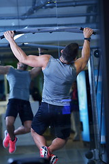 Image showing handsome man exercising at the gym