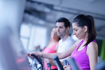 Image showing Group of people running on treadmills