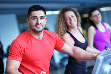 Image showing Group of people running on treadmills