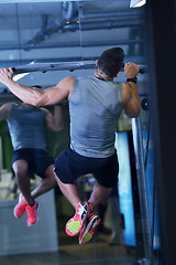 Image showing handsome man exercising at the gym