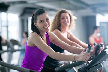 Image showing Group of people running on treadmills