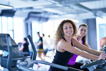 Image showing Group of people running on treadmills