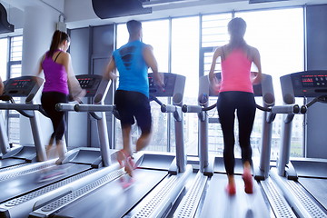 Image showing Group of people running on treadmills