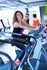 Image showing Group of people running on treadmills