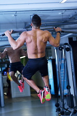 Image showing handsome man exercising at the gym