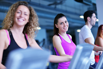 Image showing Group of people running on treadmills