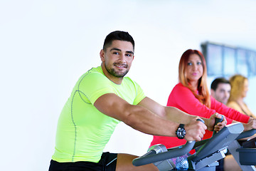 Image showing Group of people running on treadmills