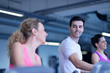 Image showing Group of people running on treadmills