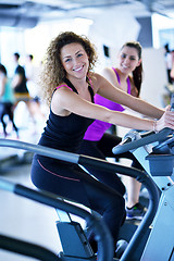 Image showing Group of people running on treadmills