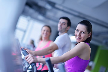 Image showing Group of people running on treadmills