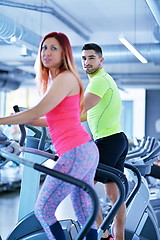 Image showing Group of people running on treadmills