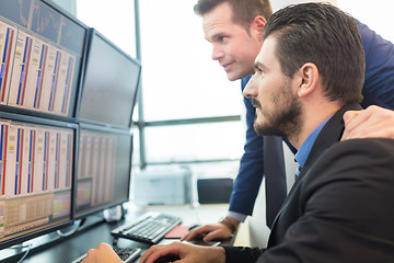 Image showing Stock traders looking at computer screens.