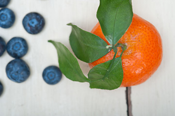 Image showing tangerine and blueberry on white table