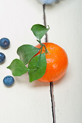 Image showing tangerine and blueberry on white table