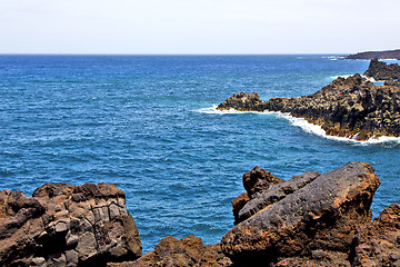 Image showing hervideros brown rock in white coast lanzarote    ummer 