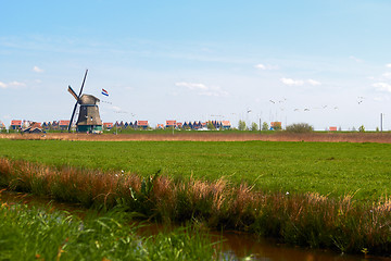 Image showing charming landscape with Dutch windmill  bright spring day