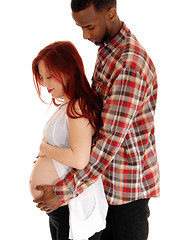 Image showing Pregnant couple holding belly.