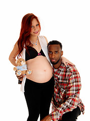 Image showing Man hugging baby belly.