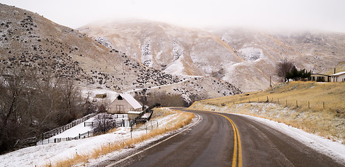 Image showing Fresh Snow Blankets Hillside Rural Country Scene Two Lane Road