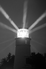 Image showing Lighthouse Beams From Lens Rainy Night Pillars of Light