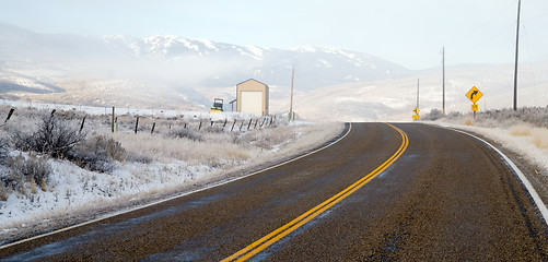 Image showing Fresh Snow Blankets Hillside Rural Country Scene Two Lane Road