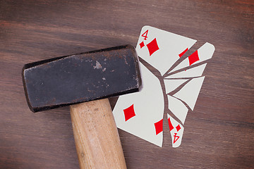 Image showing Hammer with a broken card, four of diamonds