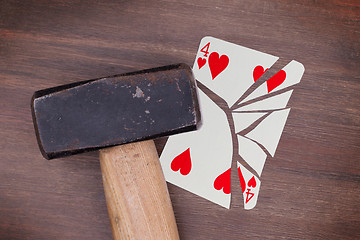 Image showing Hammer with a broken card, four of hearts