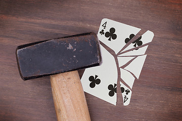 Image showing Hammer with a broken card, four of clubs
