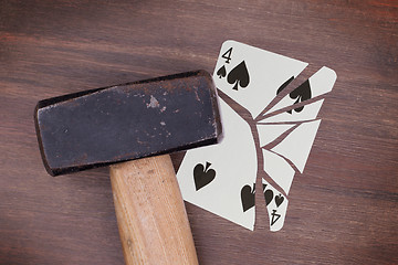 Image showing Hammer with a broken card, four of spades