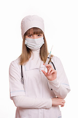 Image showing Health worker in uniform and mask with syringe