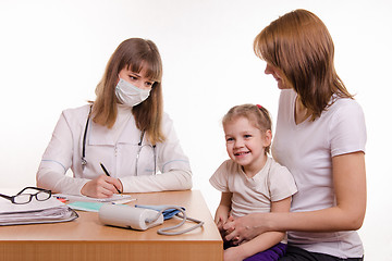 Image showing Young mother with her child sitting in his office at the pediatrician