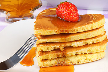 Image showing Heart-shaped pancakes with maple syrup and strawberry