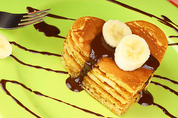 Image showing Heart shaped pancakes with chocolate sauce and banana