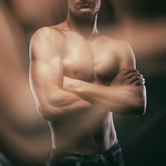 Image showing Muscular naked man on black