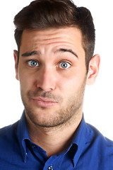 Image showing Young man making a funny face over a white background