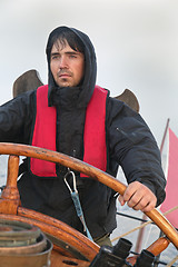 Image showing Young sailor steering tall ship